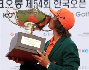 Rickie Fowler kisses the trophy after winning the Korea Open in Cheonan, South Korea.